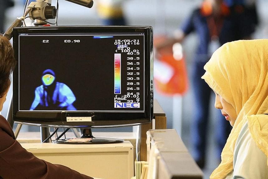 Arriving passengers from the Middle East pass by a thermal camera at Incheon airport, west of Seoul, South Korea, on May 21, 2015.&nbsp;South Korean health officials confirmed the country's third case of Middle East Respiratory Syndrome (Mers) on Thu