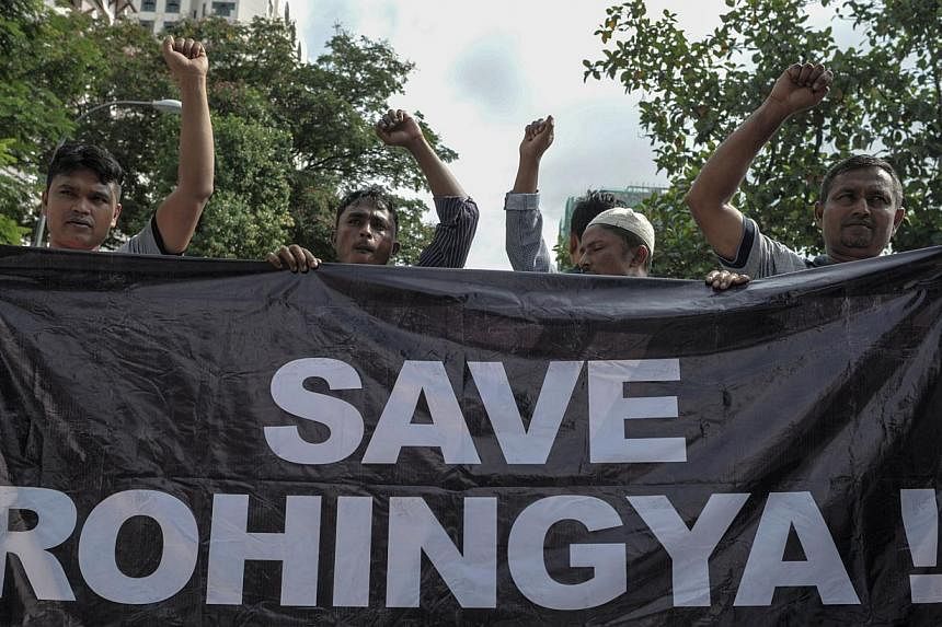 Ethnic Rohingya refugees from Myanmar residing in Malaysia protesting outside the Myanmar embassy in Kuala Lumpur on May 21, 2015.&nbsp;The United Nations says desperate relatives are buying back some migrants on boats that are stranded off Banglades