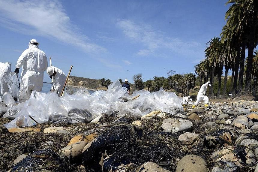 Workers clean up after an underwater oil pipe ruptured spilling an estimated 21 thousands gallons of oil into the Pacific Ocean near Refugio State Beach, 30 miles north of Santa Barbara, California, USA, May 20. Dozens of workers plied the four miles