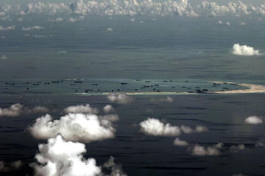 An aerial view of Mischief Reef, one of seven rocky outcrops in the Spratly islands where China is rapidly building massive artificial islands. The Chinese navy warned a US surveillance plane to leave the area eight times, according to CNN. -- PHOTO: