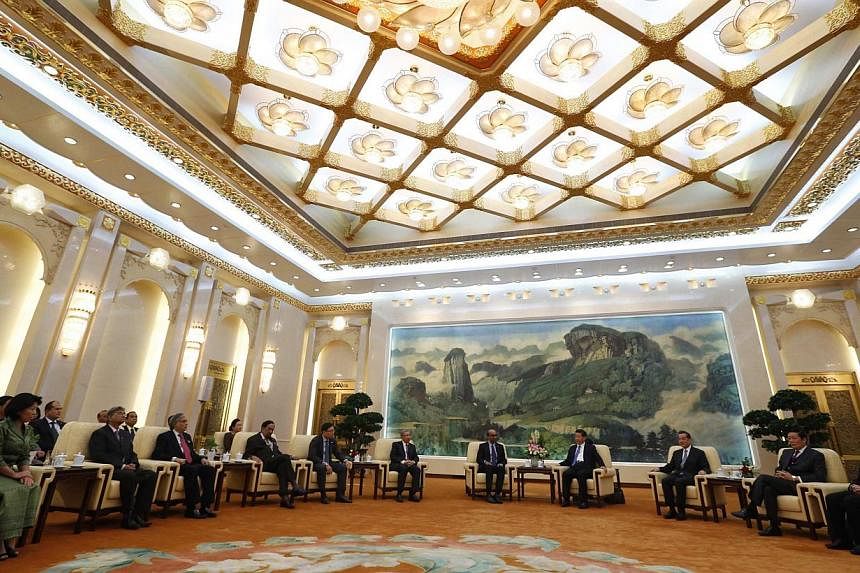 China's President Xi Jinping (fourth from right) meeting guests at the Asian Infrastructure Investment Bank launch ceremony at the Great Hall of the People in Beijing in this Oct 24, 2014 photograph. -- PHOTO: REUTERS