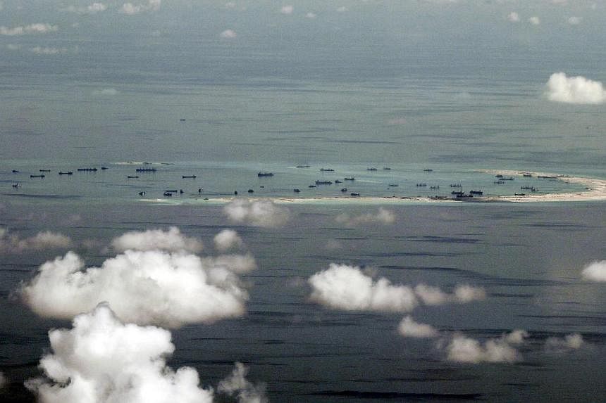 US officials have said they are weighing sending warships and surveillance aircraft within 12 nautical miles of the man-made islands in the South China Sea to test Beijing's controversial territorial claims. -- PHOTO: REUTERS
