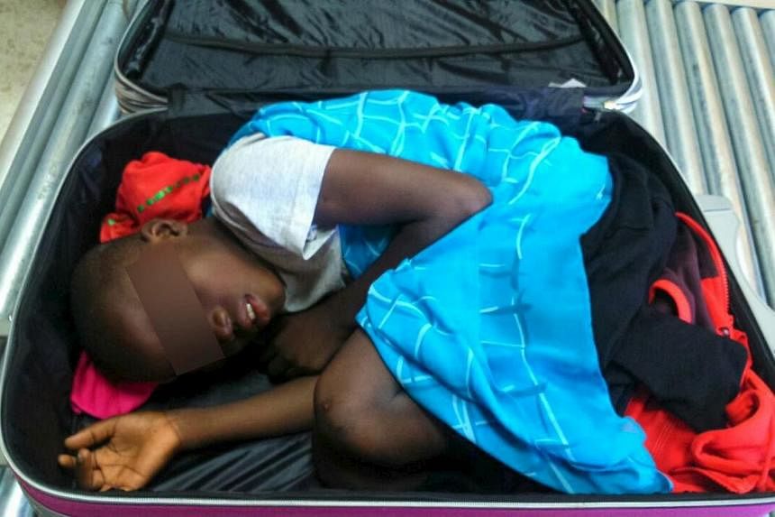 An eight-year-old boy is seen cramped inside a suitcase on a Spanish civil guard border security check point between Morocco and Spain's north african enclave Ceuta, Spain in this handout photo released May 8, 2015. -- PHOTO: REUTERS