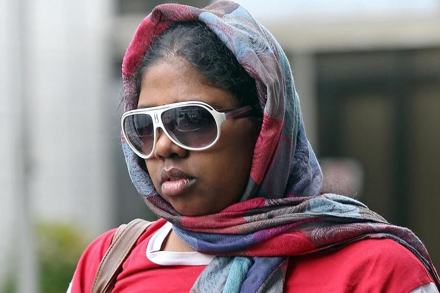 Suganthi Jayaraman, 33,&nbsp;who is charged with maid abuse, is photographed leaving the State Courts on May 22, 2015. &nbsp;She had used household items to hit and burn her domestic worker. -- ST PHOTO: SEAH KWANG PENG