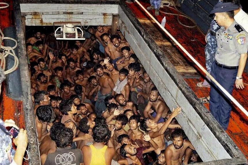 A photo provided by the Myanmar Information Ministry shows Myanmar police officers on a fishing boat filled with migrants in Rakhine on May 22, 2015. Indonesia has told Australia that most of the migrants stranded at sea in South-east Asia are illega