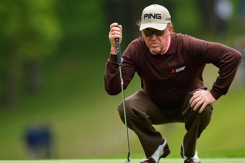 Spanish golfer Miguel Angel Jimenez lines up his put on the 1st green on the second day of the PGA Championship at Wentworth Golf Club in Surrey, south west of London, England, on May 22, 2015. -- PHOTO: AFP