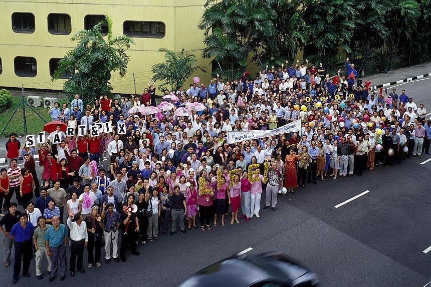 Straits Times staff gather for a group shot outside the Times House in 2002, days before the ST newsroom moved to Toa Payoh North. The iconic building had housed the ST office for more than four decades. On July 18 and 19, ST is hosting a reunion of 