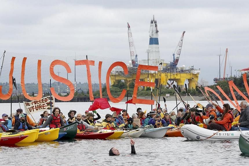 Environmental activists who fanned out in small boats across a Seattle bay over the weekend in a protest over Royal Dutch Shell's plans for Arctic oil exploration in the have damaged "precious habitat" on the sea floor, a state official said on Frida