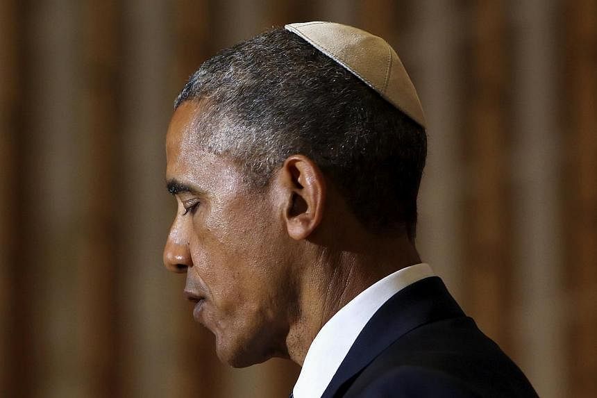 US President Barack Obama wears a traditional head covering as he delivers remarks on Jewish American History Month at the Adas Israel Congregation synagogue in Washington May 22, 2015. -- PHOTO: REUTERS