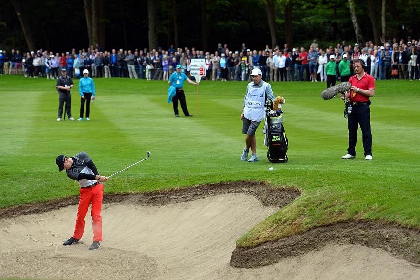 Northern Irish golfer Rory McIlroy plays his third shot from his second bunker on the 3rd fairway on the second day of the PGA Championship at Wentworth Golf Club in Surrey, south-west of London, England, on May 22, 2015. -- PHOTO: AFP