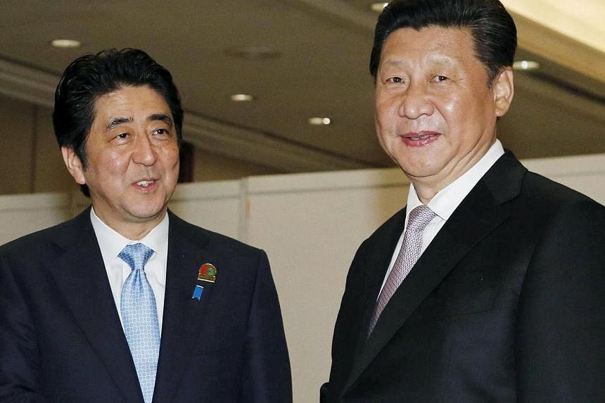 China's President Xi Jinping (right) meeting Japan's Prime Minister Shinzo Abe at&nbsp;a conference in Jakarta on April 22, 2015. -- PHOTOS: REUTERS