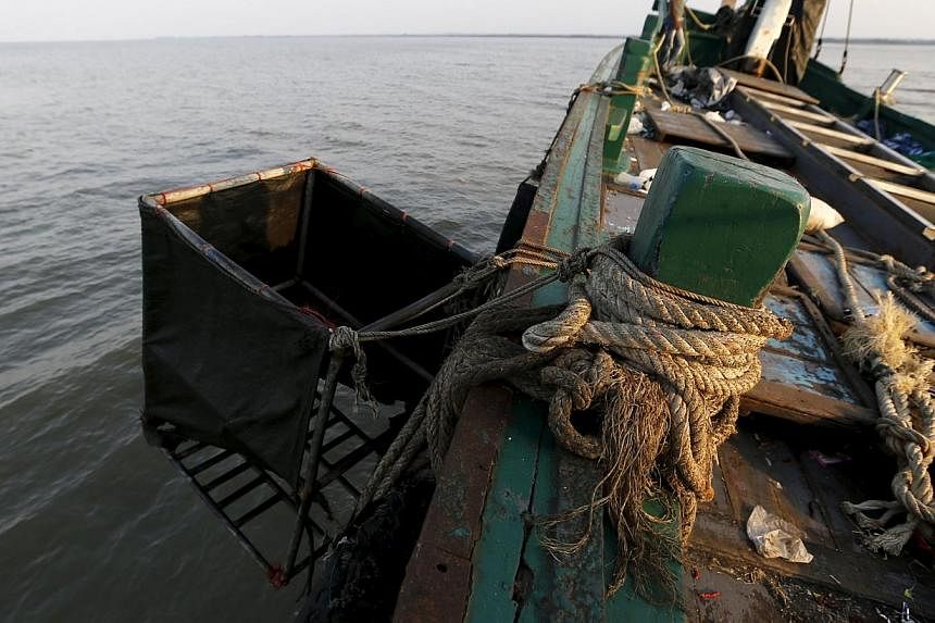 A makeshift toilet hangs off an abandoned boat which carried Rohingya and Bangladeshi migrants from Thailand, found off the coast near the city of Kuta Binje in Indonesia's Aceh Province on May 20, 2015. -- PHOTO: REUTERS