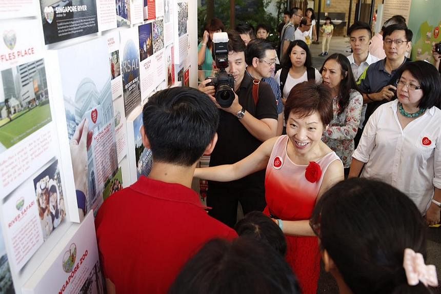 Minister in the Prime Minister's Grace Fu (centre), who is the co-chair of the SG50 Environment and Infrastructure Committee overseeing the SG Heart Map project, touring an exhibition with the unveiling of the 50 SG Heart Map places at Sentosa Siloso