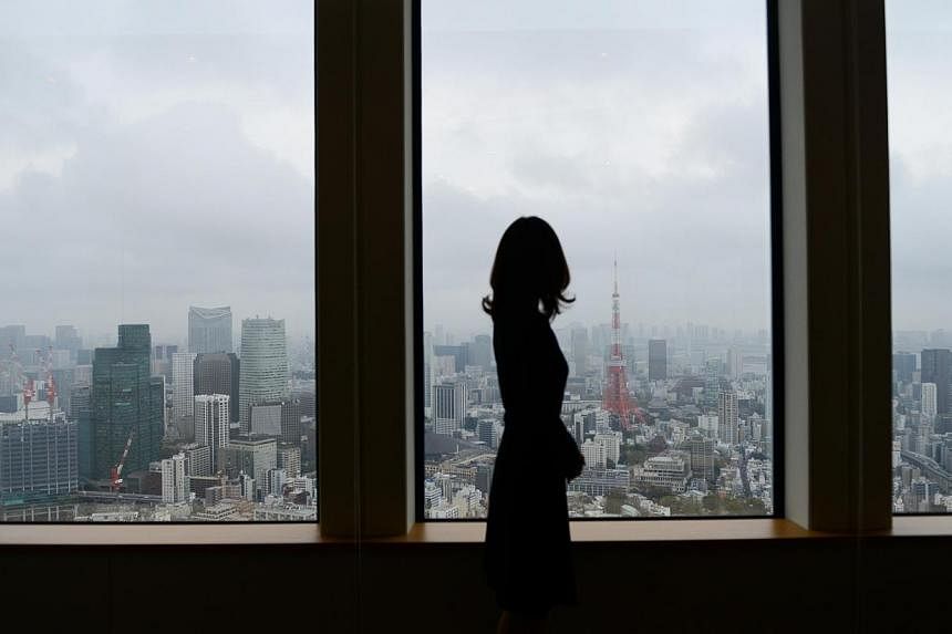 Japan's push to take away overtime from high-paid workers has critics warning that it will aggravate a problem synonymous with the country's notoriously long working hours - karoshi, or death from overwork. -- PHOTO: BLOOMBERG