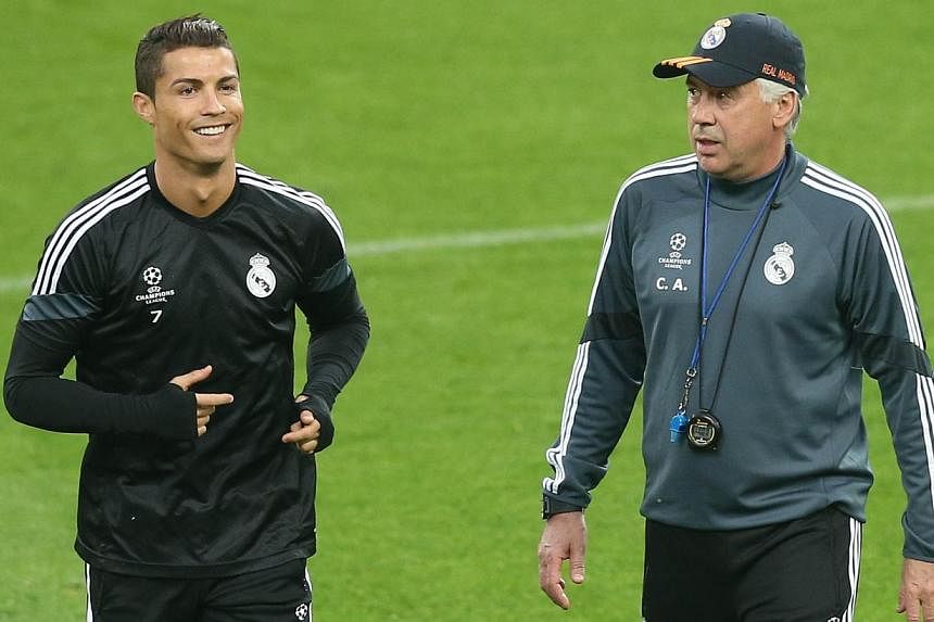 Real Madrid forward Cristiano Ronaldo (left) and coach Carlo Ancelotti at a training session on May 4, 2015. -- PHOTO: AFP