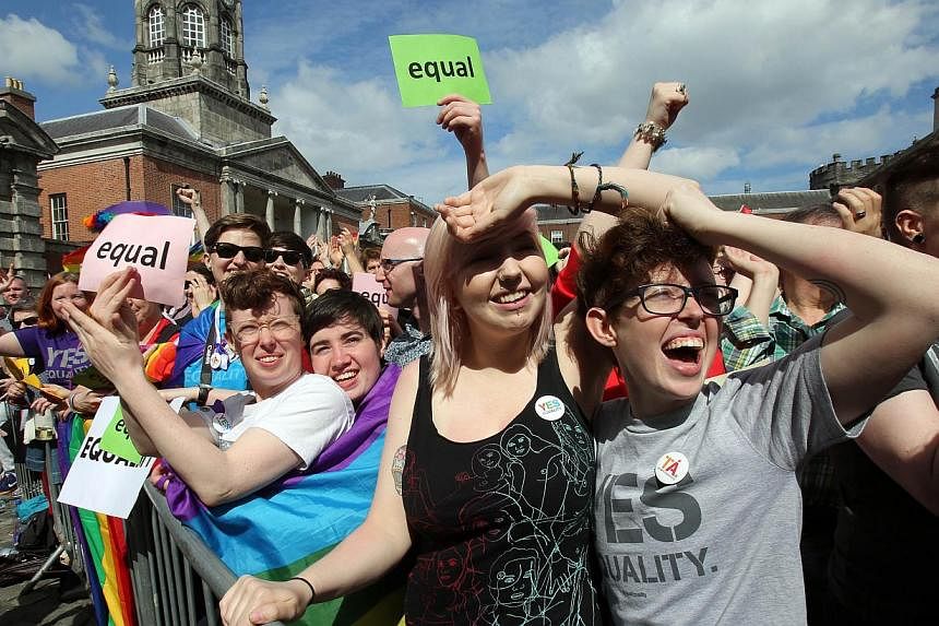 Supporters for same-sex marriage raise a cheer at Dublin Castle as they wait for the result of the referendum on May 23, 2015. -- PHOTO: AFP