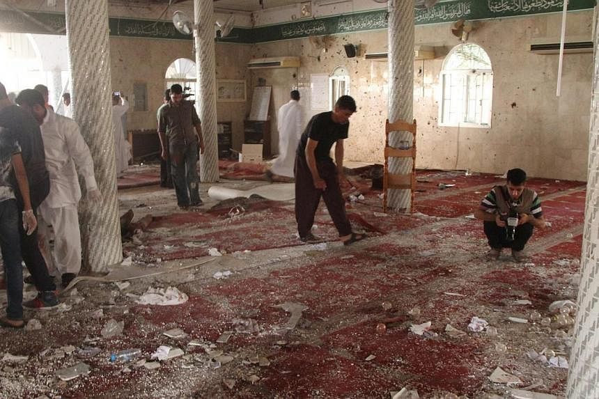 People examine the debris after a suicide bomb attack at the Imam Ali mosque in the village of al-Qadeeh in the eastern province of Gatif, Saudi Arabia on May 22, 2015. -- PHOTO: REUTERS