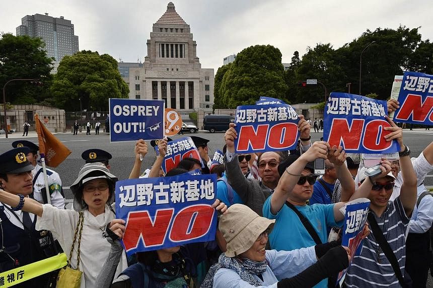 People stage a rally in front of the parliament (centre, top) in Tokyo on May 24, 2015 to protest against a controversial US airbase on Okinawa island, in southern Japan.&nbsp;-- PHOTO: AFP&nbsp;