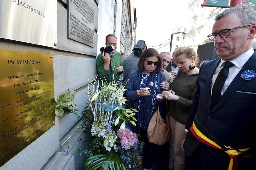 Brussels' Mayor Yvan Mayeur (right) attends a ceremony for the victims of the May 24, 2014 attack at the entrance of the Jewish Museum in Brussels, Belgium, on May 24, 2015. -- PHOTO: REUTERS&nbsp;