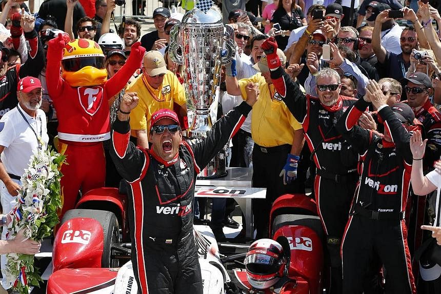 Juan Pablo Montoya of Colombia, driver of the #2 Team Penske Chevrolet Dallara celebrates after winning the 99th running of the Indianapolis 500 mile race at the Indianapolis Motor Speedway on May 24, 2015 in Indianapolis, Indiana. -- PHOTO: AFP