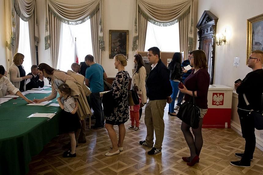 Voters wait to be registered at a polling station within the Polish Embassy in Central London, on May 24, 2015 during Poland's presidential election run-off. -- PHOTO: EPA