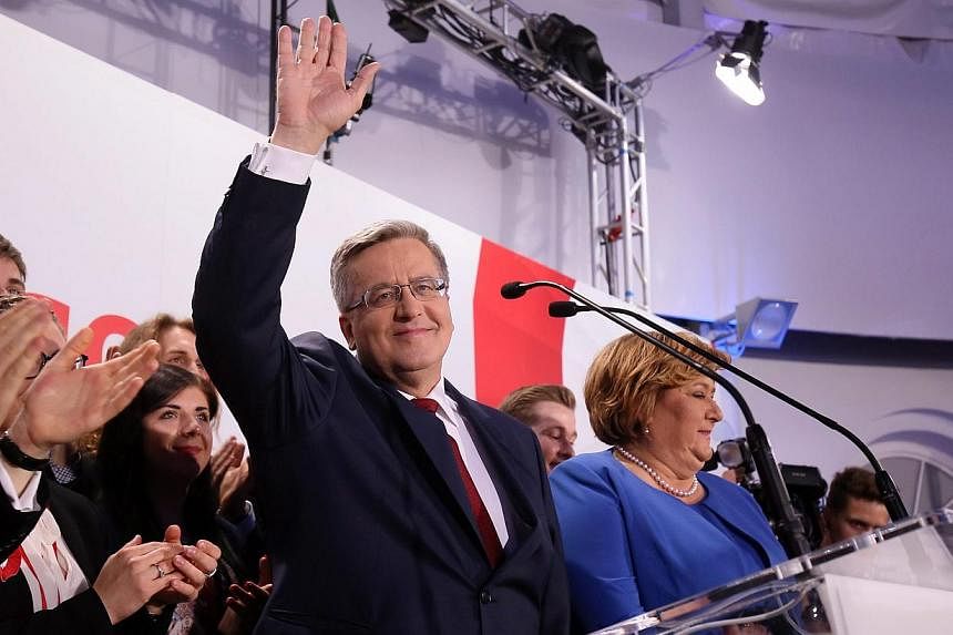 Poland's president and presidential candidate Bronislaw Komorowski (centre) speaks during the presidential elections night in Warsaw, Poland, on May 24, 2015. -- PHOTO: EPA