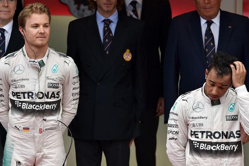 Mercedes driver Lewis Hamilton of Britain, who finished in third place at the Monaco Grand Prix, standing next to teammate and rival Nico Rosberg of Germany, who won the race, on Sunday, May 24, 2015. Hamilton was left stunned after an error robbed h