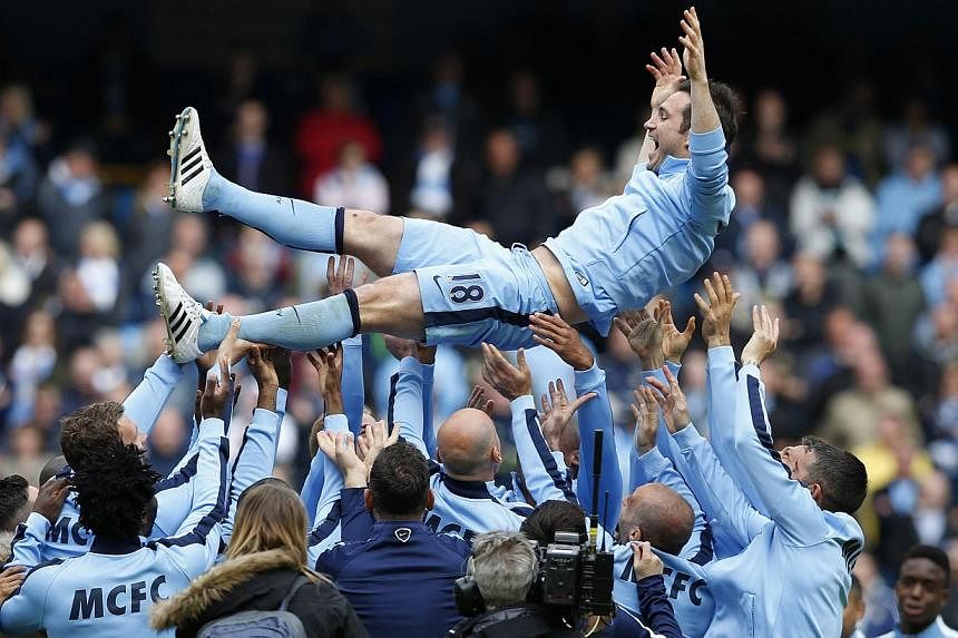Manchester City's Frank Lampard is thrown in the air by team mates after the game between Manchester City and Southampton on May 24, 2015. -- PHOTO: REUTERS&nbsp;