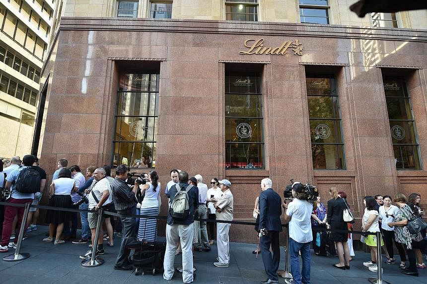 Members of the public queue outside the Lindt Cafe at Martin Place in Sydney ahead of the re-opening on March 20, 2015.&nbsp;&nbsp;A self-styled sheikh who staged a siege at the cafe last year suffered "grandiose delusions" and was once kicked out of