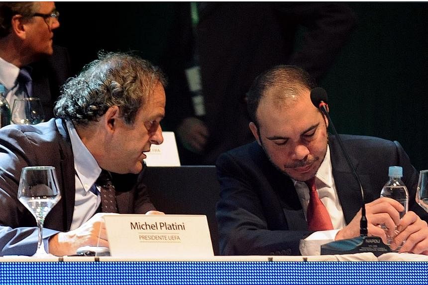 Uefa president Michel Platini (left) and Fifa presidential candidate Jordan Prince Ali bin Al Hussein chat during the 65th Ordinary Congress of the CONMEBOL, at the South American confederation's headquarters in Luque, near Asuncion on March 4, 2015.