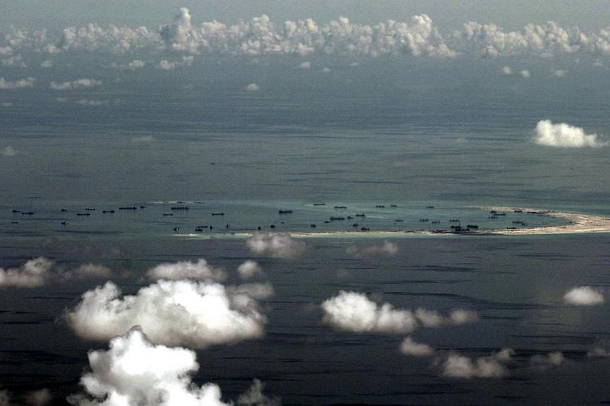 An aerial file photo taken though a glass window of a Philippine military plane shows alleged on-going land reclamation by China on Mischief Reef in the Spratly Islands in the South China Sea, on May 11, 2015.&nbsp;Philippine military and commercial 