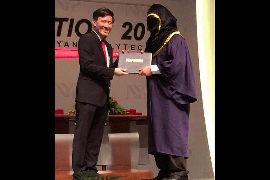 A student from Nanyang Polytechnic turned up for his convocation ceremony last week with a hood covering his entire face. -- PHOTO:&nbsp;SHIN MIN DAILY NEWS
