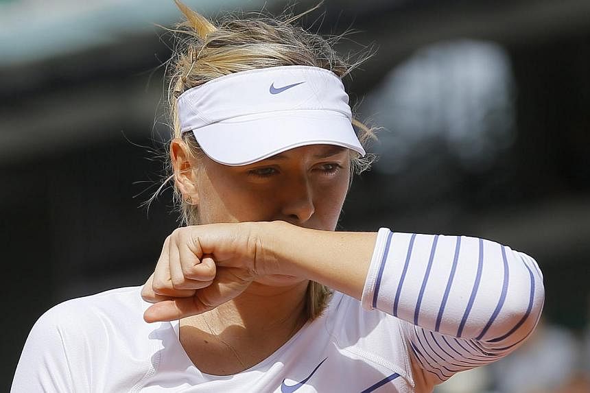 Defending French Open women's champion Maria Sharapova (above) was jeered off the court when she refused to carry out the traditional on-court TV interview, claiming a cold, after her first round win over Vitalia Diatchenko at Roland Garros on May 25