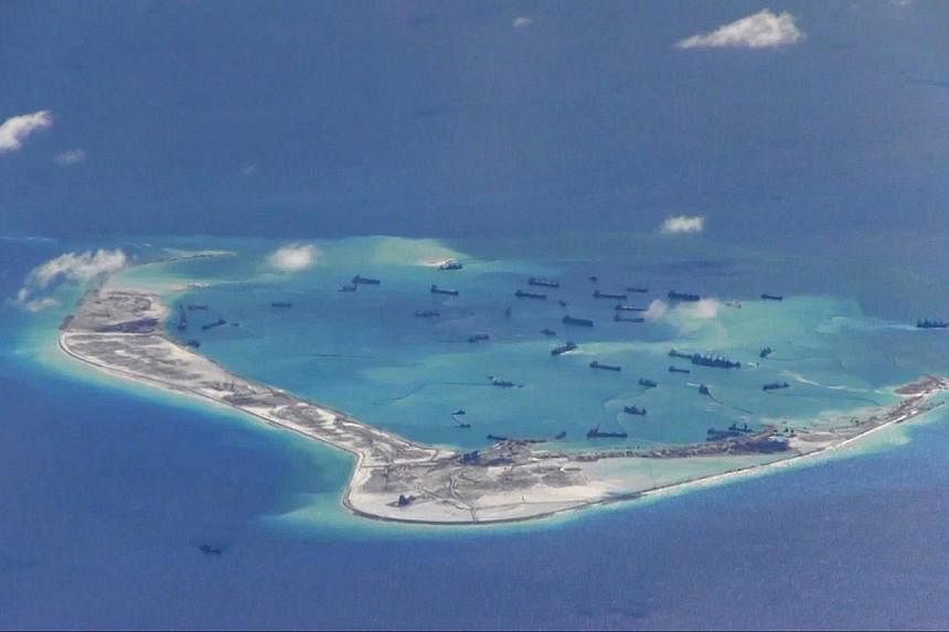 Chinese dredging vessels are purportedly seen in the waters around Mischief Reef in the disputed Spratly Islands in the South China Sea, in this file still image from video taken by a P-8A Poseidon surveillance aircraft and provided by the United Sta