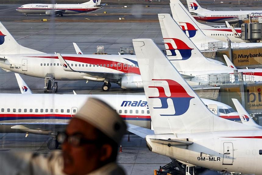 Malaysia Airlines planes are seen on the tarmac at the Kuala Lumpur International Airport in this March 12, 2014 file photograph. The loss-making airline is set to undergo a complete overhaul as it is restructured into a new company. -- PHOTO: REUTER
