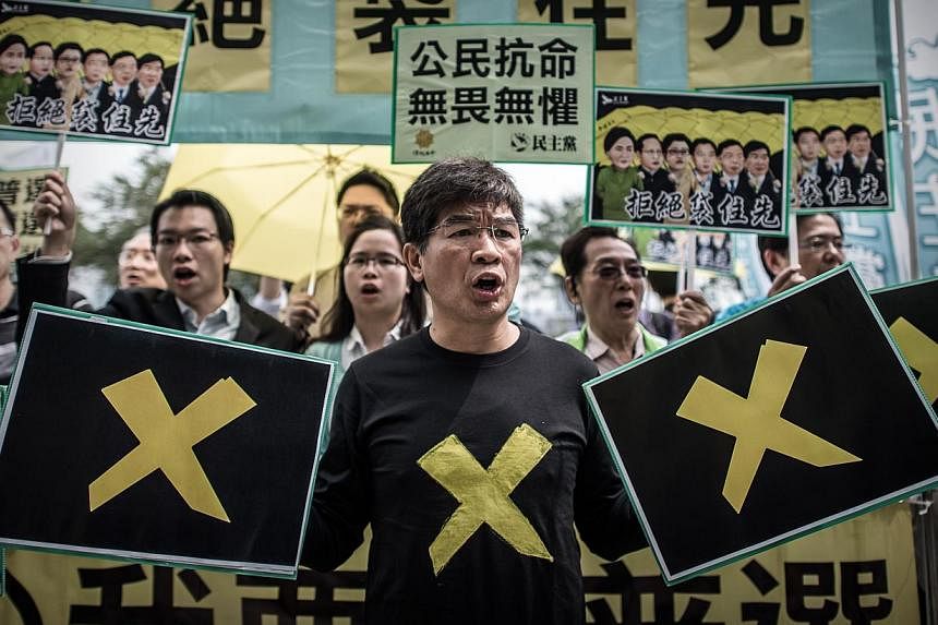 Pro-democracy demonstrators stage a protest outside the government building in Hong Kong on April 22, 2015. -- PHOTO: AFP