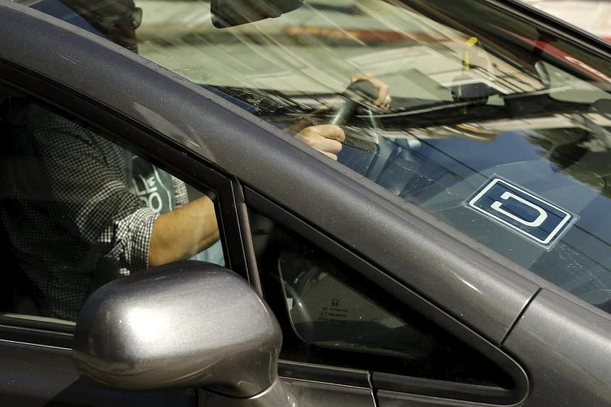 An Uber logo shown on a vehicle in San Francisco, California on May 7, 2015. -- PHOTO: REUTERS&nbsp;