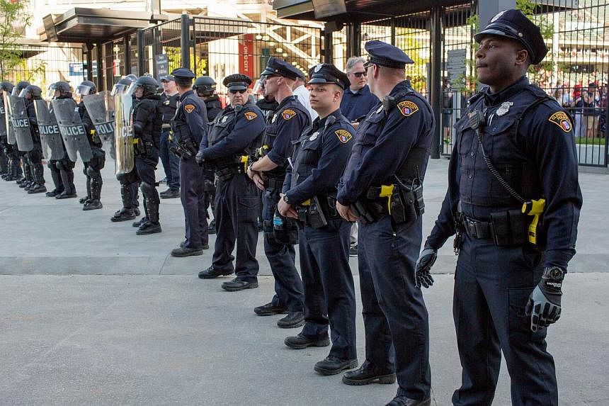Police in front of Progressive Field stand guard during demonstrations in reaction to Cleveland police officer Michael Brelo being acquitted of manslaughter charges after he shot two people at the end of a 2012 car chase in which officers fired 137 s