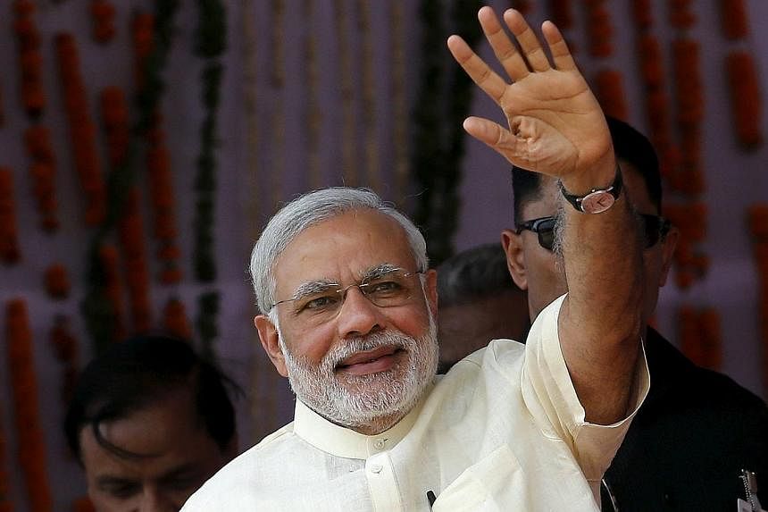India's Prime Minister Narendra Modi waves towards his supporters during a rally in Mathura, India on May 25, 2015. -- PHOTO: REUTERS