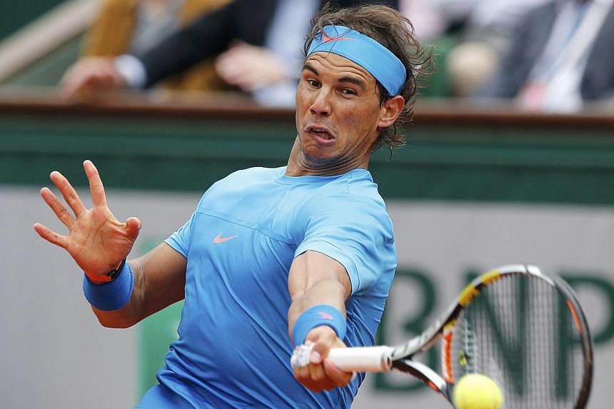 Rafael Nadal of Spain plays a shot to Quentin Halys of France during their men's singles match at the French Open tennis tournament at the Roland Garros stadium in Paris, France on May 26, 2015. -- PHOTO: REUTERS &nbsp;