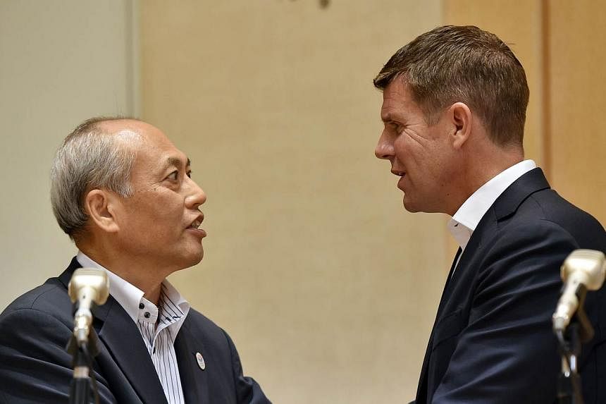 Australia's New South Wales state premier Mike Baird (Right) shakes hands with Tokyo Governor Yoichi Masuzoe (Left) after exchanging an agreement for cooperation regarding the Tokyo 2020 Olympic Games at the Tokyo city hall on May 19, 2015. On Tuesda