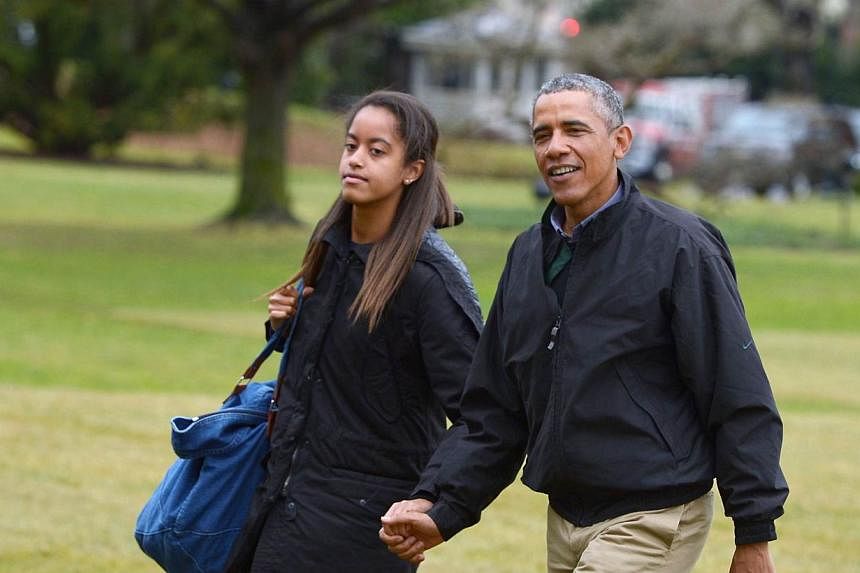 US President Barack Obama (right) and his daughter Malia walk across the South Lawn upon return to the White House in Washington, DC on Jan 4, 2015. A Kenyan lawyer has offered Mr Obama 50 cows and other assorted livestock in exchange for his 16-year