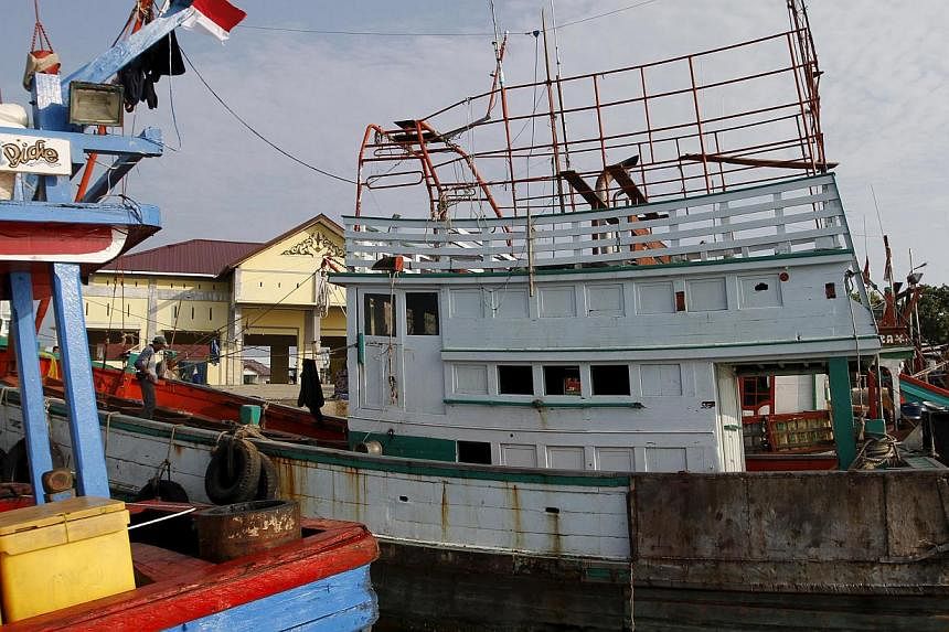 A fishing boat which carried Rohingya and Bangladeshi migrants is seen at a port in Lhokseumawe, Indonesia's Aceh Province on May 13, 2015. -- PHOTO: REUTERS