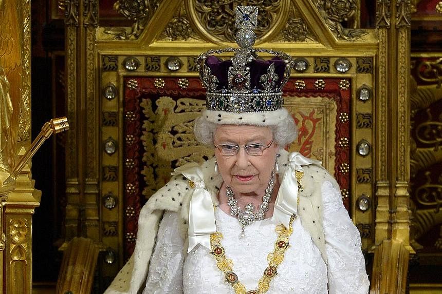 In this file photograph taken on June 4, 2014, Britain's Queen Elizabeth delivers the Queen's Speech from the Throne in the House of Lords during the State Opening of Parliament at the Palace of Westminster in London. -- PHOTO: AFP