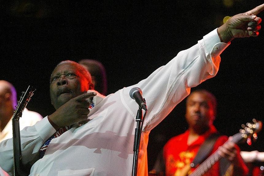 A June 23, 2004 file photo shows US musician BB King performs during a concert at the bullring of Valencia. -- PHOTO: AFP