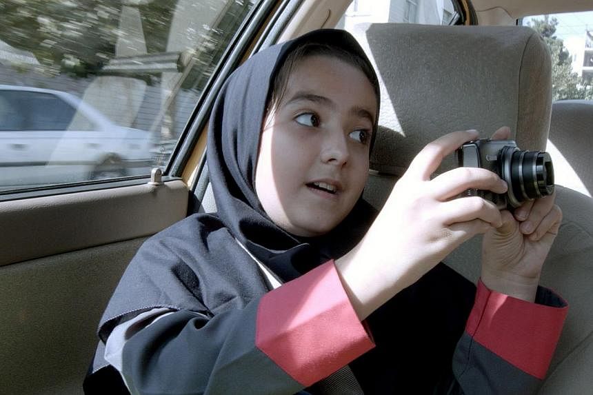 A precocious Hana Saedi, the director's own niece, is the highlight among the passengers in Taxi Tehran, who recites the regime-approved tenets for good film-making in the movie. -- PHOTO: THE PROJECTOR