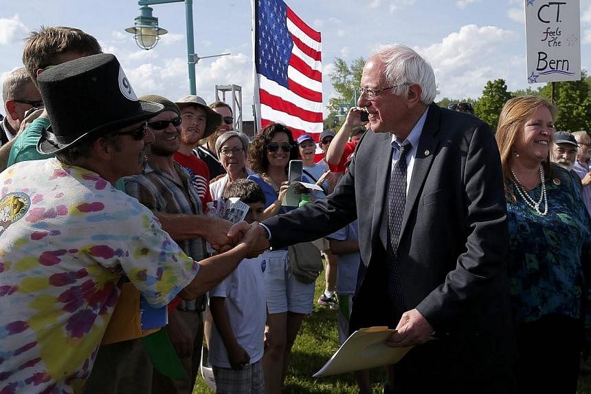 Democratic presidential candidate Senator Bernie Sanders (right) greets supporters as he arrives at a "hometown kickoff" campaign event in Burlington, Vermont, on May 26, 2015. -- PHOTO: REUTERS