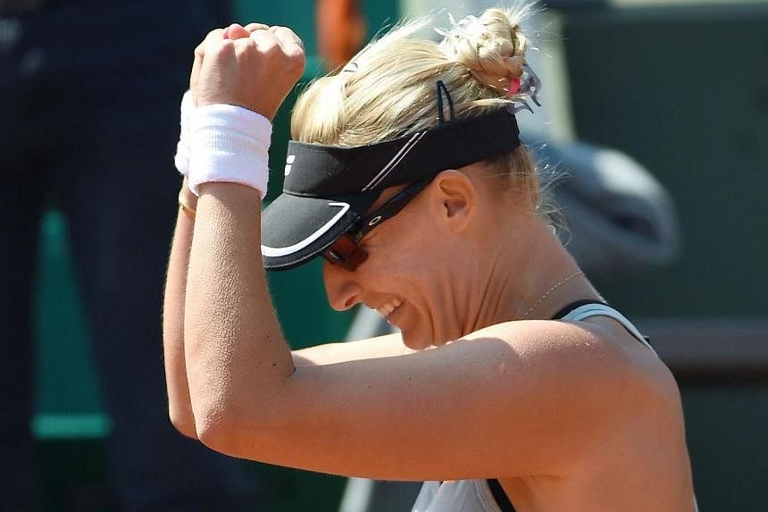 Croatia's Mirjana Lucic-Baroni celebrates after defeating Romania's Simona Halep during the women's second round at the Roland Garros 2015 French Tennis Open in Paris on May 27, 2015.&nbsp;-- PHOTO:&nbsp;AFP