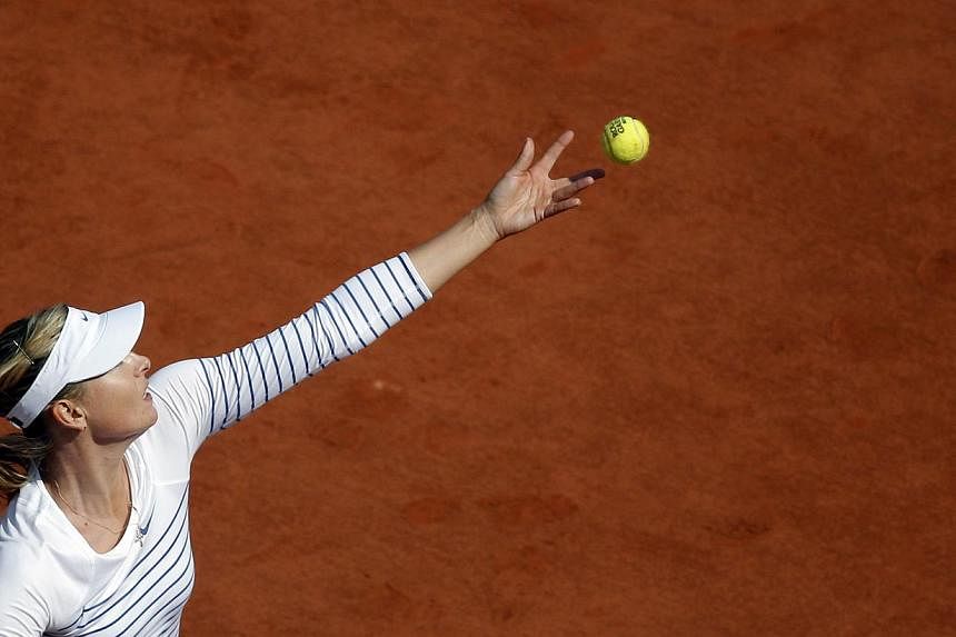 Maria Sharapova of Russia serves against Vitalia Diatchenko of Russia during their second round match for the French Open tennis tournament at Roland Garros in Paris, France on May 27, 2015. -- PHOTO: EPA