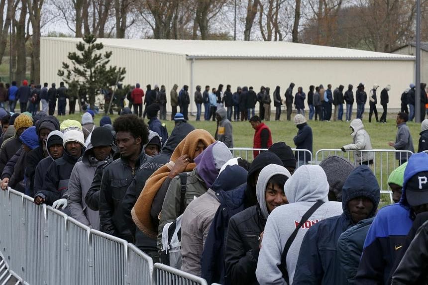 Migrants from Africa, Afghanistan and Syria queue for an evening meal at the Jules Ferry day centre in Calais, France on April 29, 2015. -- PHOTO: REUTERS